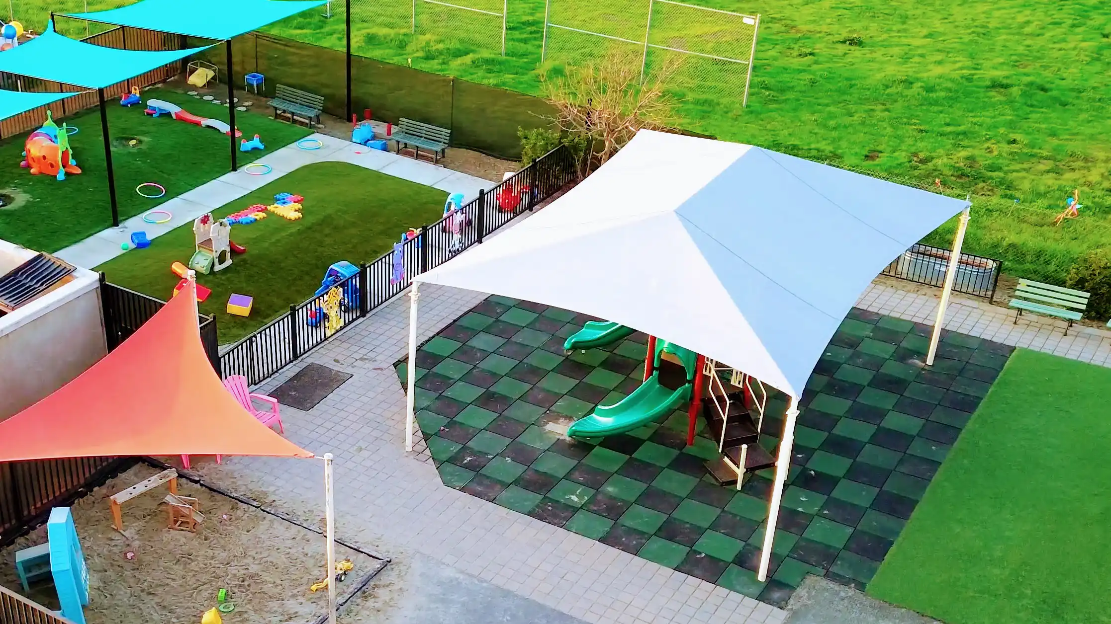 Overhead view of Celebration Center’s outdoor play area featuring shaded playground equipment and secure open spaces